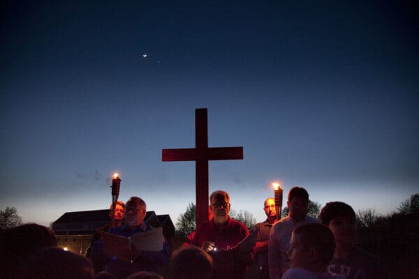 LISA JOHNSTON | lisajohnston@archstl.org  Tim Reardon and Len Kiessel carried torches while Joseph Dunne carried a cross at Our Lady of Providence's outdoor Stations of the Cross.   Beginning in front of church and following through the woodlands on the Parish grounds, the men’s Acts team members led the parish school of religion, current Annunciation and OLP men’s ACTs team and parishioners through the outdoor devotion. Many participated in an actual nailing of nails onto a large wooden cross to signify the crucifixion. The outdoor Stations of the Cross experience was established in 2008 to be a peaceful walk through nature while in prayer and meditation.