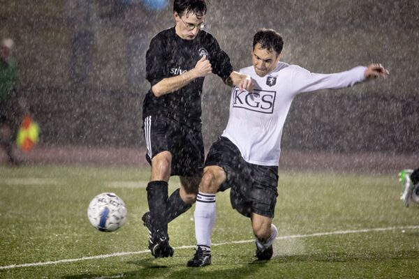 Lisa Johnston | lisajohnston@archstl.org  | Twitter: @aeternusphoto Father Anthony Gerber lost the ball after a kick from Christopher Venverloh. Priests of the Archdiocese of St. Louis battled against Kenrick-Glennon Seminarians in the 2015 Souls and Goals soccer match at St. Dominic High School. The priests won the match 2-0 though the game was called off early due to severe thunderstorms.