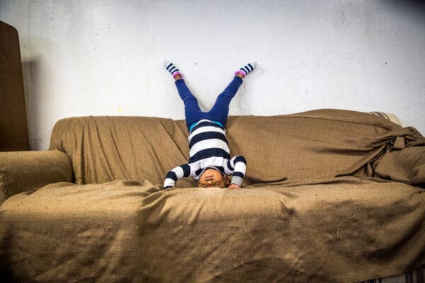 Lisa Johnston  | lisajohnston@archstl.org  |  twitter: @aeternusphoto

3-year-old Haley Marie, practiced headstands on the couch in the activity room at Our Lady's Inn. Our Lady’s Inn is a maternity home for pregnant women living in homelessness and it also provides for their dependent children.  Alanda has been living at the shelter since December with her five children, the lastest, a baby girl named Royal.