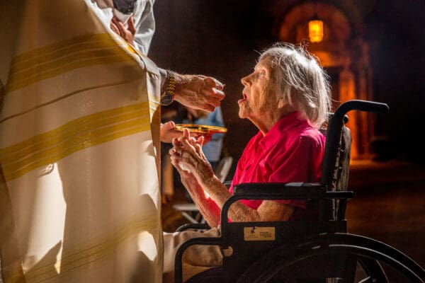 Lisa Johnston  |  lisajohnston@archstl.org  |  @aeternusphoto  

94-year-old Catherine Rozycke received the Eucharist from Father Timothy Elliott on July 22, the last night of the Novena to Our Lady of Mount Carmel.  Catherine Rozycke has attended the Our Lady of Mount Carmel annual outdoor novena for the entire 70 years it has existed.