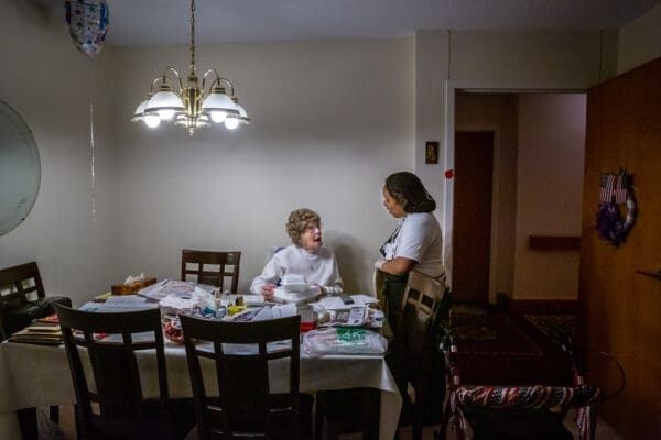 Since the dinning room if closed, Breanna Taylor delivers dinners door to door at Our Lady of Life Apartments in Shrewsbury, Missouri on Monday, Mar 23, 2020. She gave a meal to Gerry Sickles in her room.

Lisa Johnston | lisajohnston@archstl.org  | Twitter: @aeternusphoto