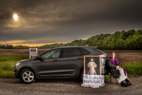 Pastor of St. Ignatius of Loyola, Father Steve Robeson sat at the corner of Highways 47 and 94 to be available for conversations in Concord Hill, Missouri on Saturday, May 09, 2020.  

Lisa Johnston | lisajohnston@archstl.org  | Twitter: @aeternusphoto