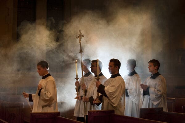 Seminarians walk down the main aisle of the chapel in procession.