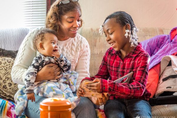 Lisa Johnston | lisajohnston@archstl.org  | Twitter: @aeternusphoto

Jamya Cresswell, age 6, wondered into Claver House for the first time and immediately began reading a book with Kim Davis and her grandson, Victor. 

Kim Davis is a grandmother and member of St. Matthew Parish in the Ville. When the neighborhood children stopped by because they were hungry, she agreed to feed them a snack, but said if you’re going to do that, we’re going to read a book.

Now, with a team of volunteers, they twice monthly host Read and Feed at the Claver House near Matthew’s.